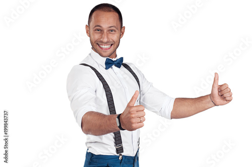 Happy men in a white shirt smiles. White shirt, bow tie, suspenders. Joyful and pleased man.