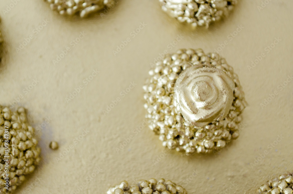 Granulated chocolate brigadier with crunchy balls topped with gold paint and a chocolate flower on top. On a golden tray. Top View. Copy space. Granulated chocolate brigadier with crunchy balls topped with gold paint and a chocolate flower on top. On a golden tray. Top View. Copy space.
