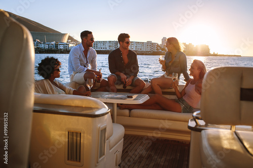 Friends having boat party at sunset © Jacob Lund