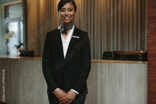 Fototapeta Female concierge ready to welcome guest