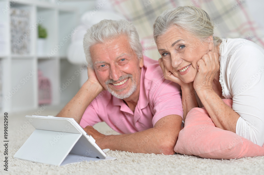 happy senior couple using tablet happy senior couple using tablet