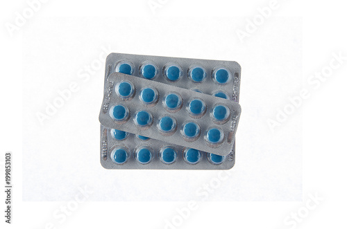 Tableau sur toile three plates of blue pills on white isolated background