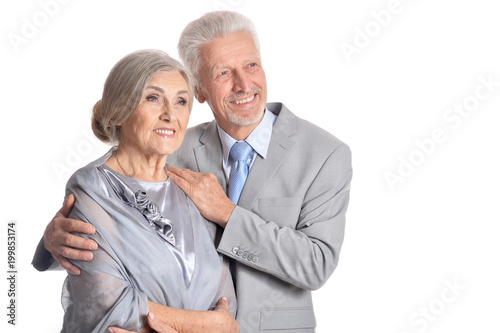 hugging senior couple on white background