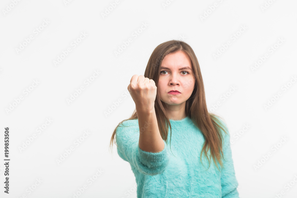 Angry aggressive woman with ferocious expression on white background Angry aggressive woman with ferocious expression on white background