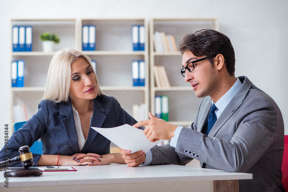 Lawyer discussing legal case with client Lawyer discussing legal case with client