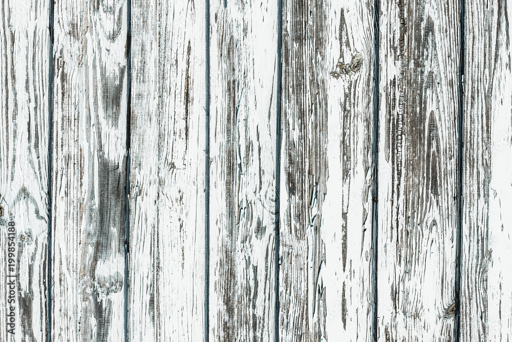 White wooden desk. Peeling paint grunge weathered wall background. White wooden desk. Peeling paint grunge weathered wall background.