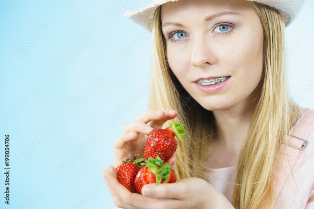 Young woman with fresh strawberries