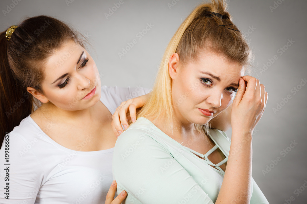 Woman hugging her sad female friend Woman hugging her sad female friend