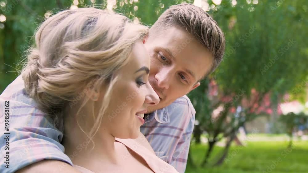 University students reading book and kissing in park, romantic leisure, love University students reading book and kissing in park, romantic leisure, love