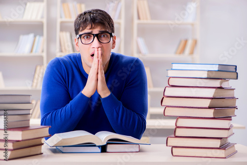 Male student preparing for exams in college library