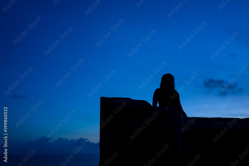 Silhouette of girl in the Uluwatu temple area in Bali