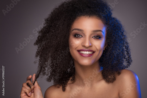 Beauty portrait of smiling dark skin young woman.