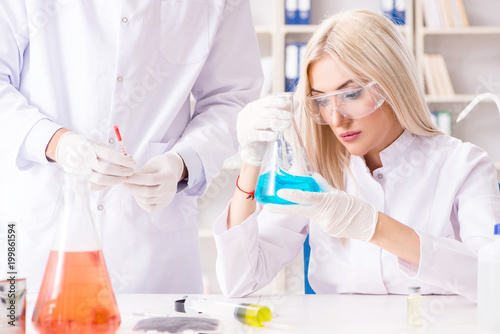 Young woman chemist working in clinic lab