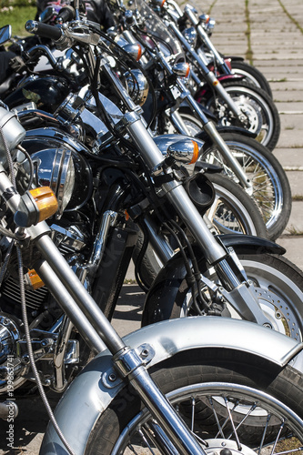 Motorcycles chppery stand in a row.