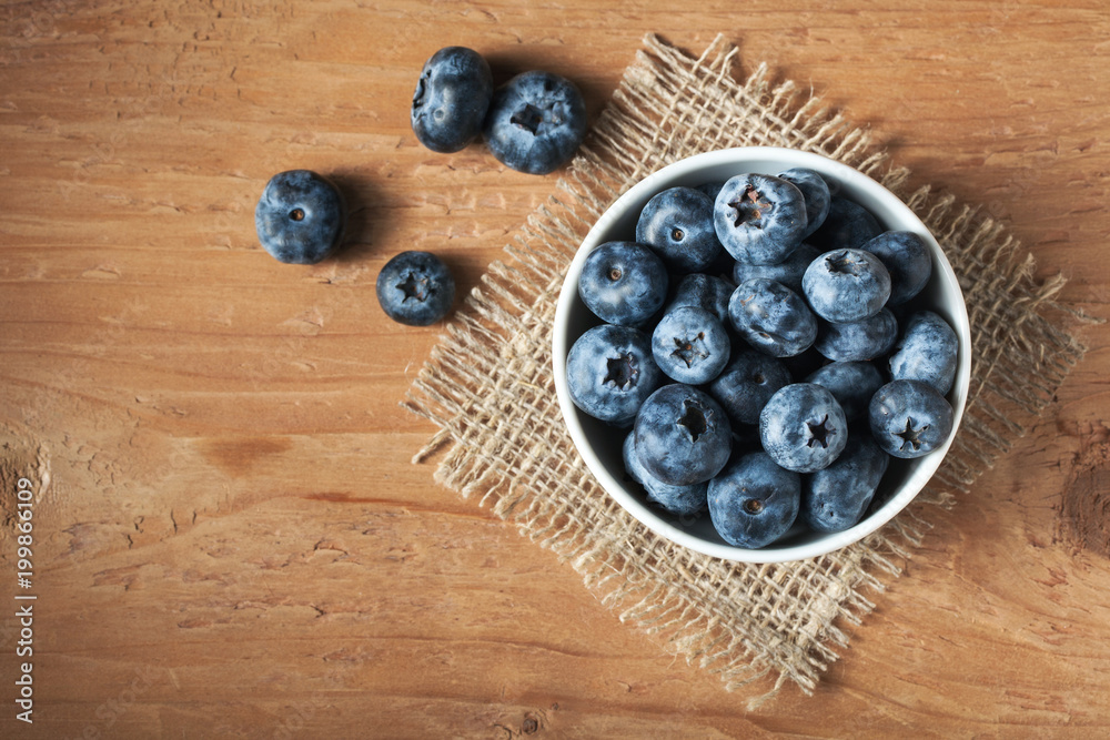 Blueberry on wooden table background. Ripe and juicy fresh picked blueberries closeup. Berries closeup top view with copy space Blueberry on wooden table background. Ripe and juicy fresh picked blueberries closeup. Berries closeup top view with copy space
