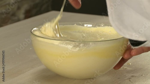 View of manual stirring dough for dessert photo