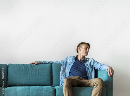 Man sitting on a sofa © Rawpixel.com
