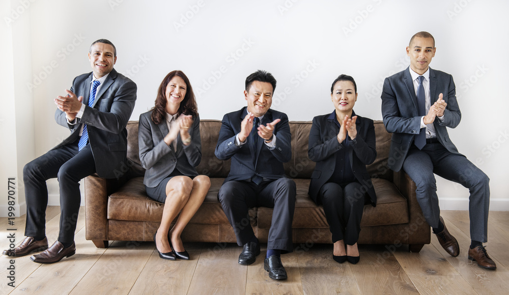 Business people sitting together on couch Business people sitting together on couch