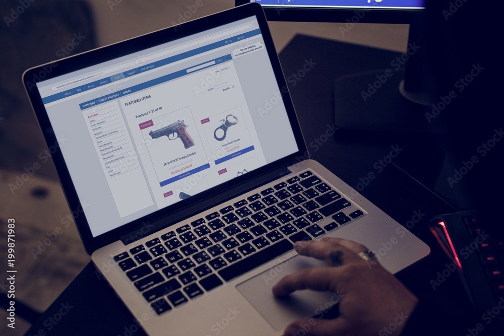 Closeup of hand ordering gun online Closeup of hand ordering gun online