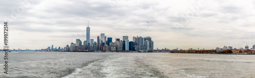 Manhattan Skyline From The Water With Cloudy Skies in Fall Season