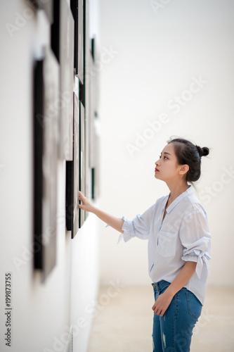 woman looking at the pictures on the wall