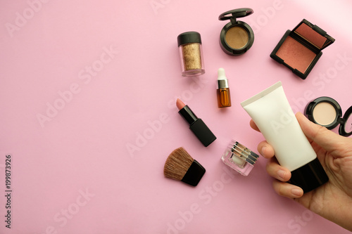 Fototapeta Naklejka Na Ścianę i Meble -  beauty cosmetic makeup , organic skincare serum product packaging with leaves herb on nature beauty concept, herb bio and spa concept.pink background.