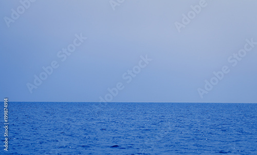 Horizon line between the sea and the sky in the summer evening