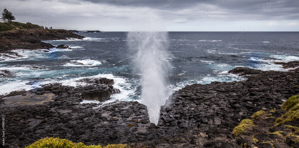 Little Kiama Blowhole. Water can be seen coming out of the blowhole when a wave strikes the coast.
