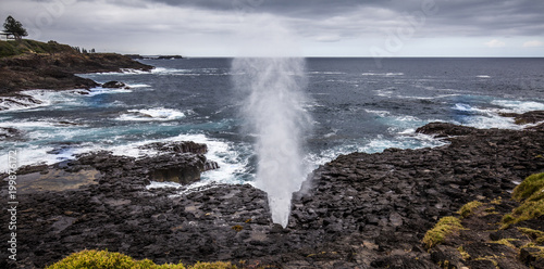 Little Kiama Blowhole. Water can be seen coming out of the blowhole when a wave strikes the coast. photo