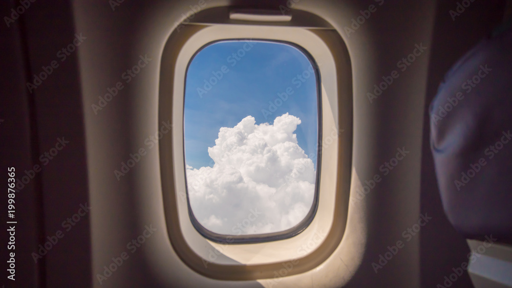 Clouds and sky as seen through window of an aircraft