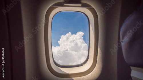 Clouds and sky as seen through window of an aircraft © Довидович Михаил