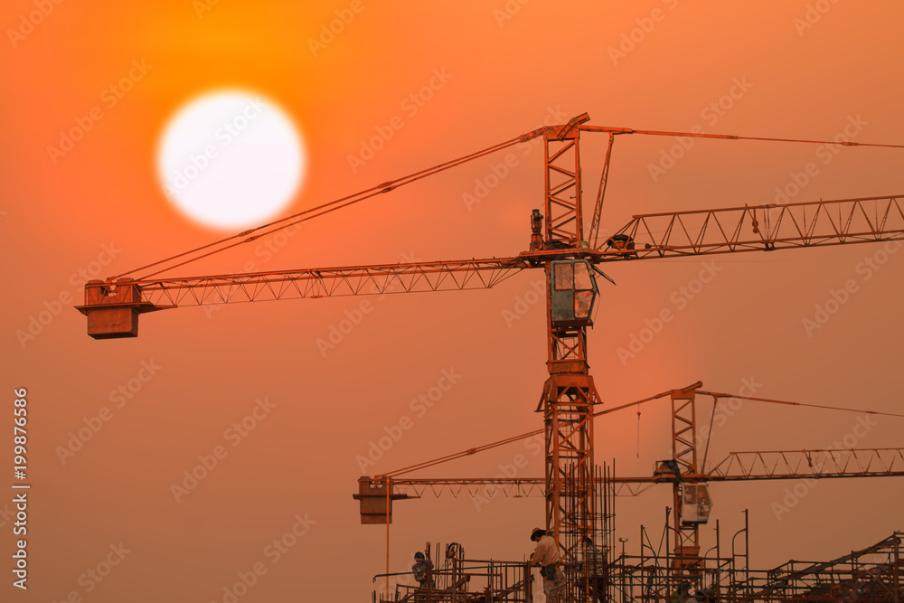 building and crane under construction with sunrise or sunset  sky background