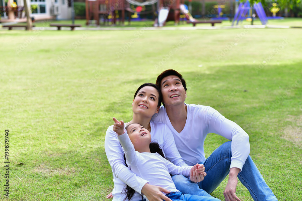 Happy male and female playing with children outside Happy male and female playing with children outside