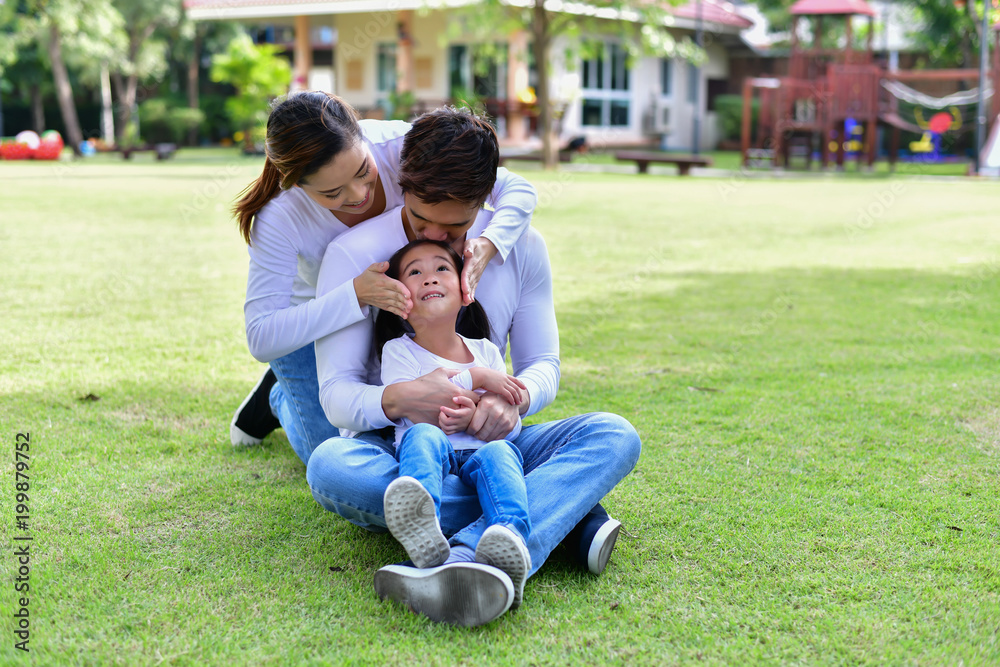 Happy male and female playing with children outside Happy male and female playing with children outside