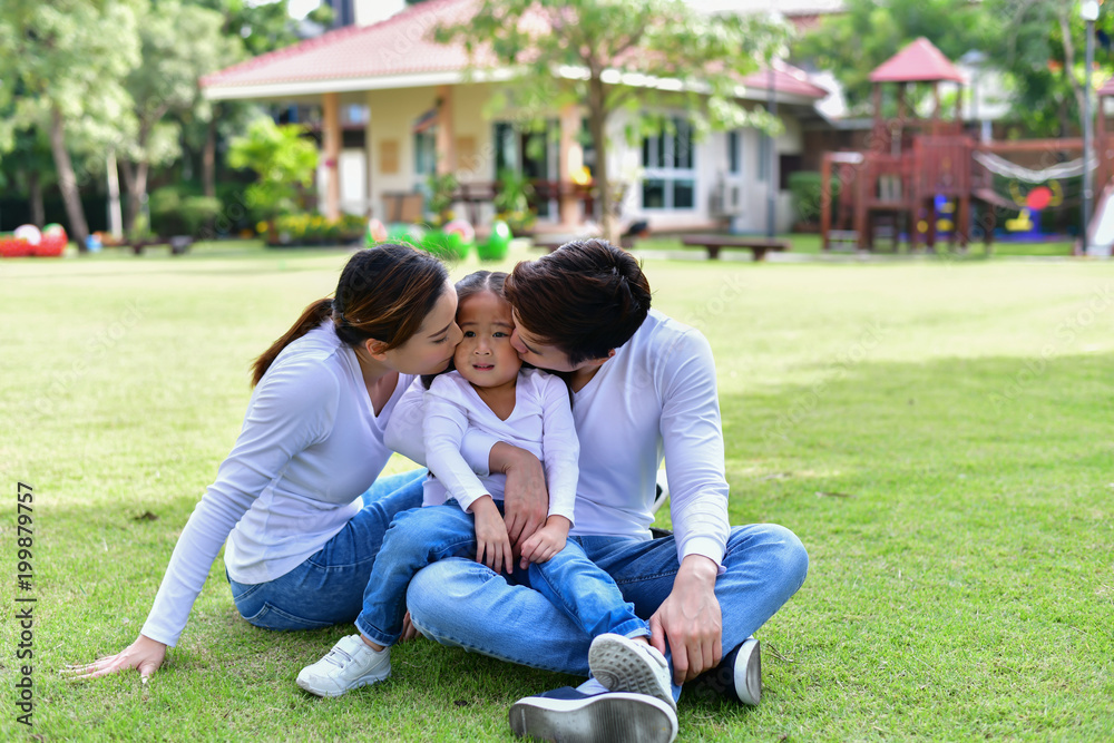 Happy male and female playing with children outside Happy male and female playing with children outside