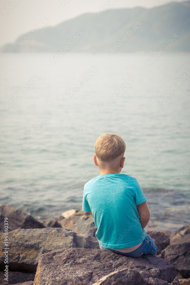 Fototapeta premium Cute caucasian boy at seaside