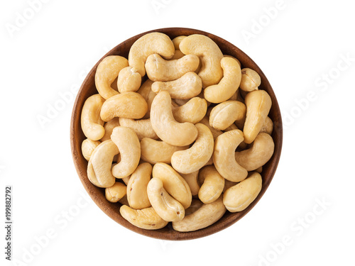 Cashew nut in wooden bowl isolated on white