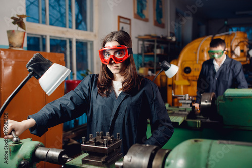 Group team Mechanic engineer turner processes manufacturing steel parts in workshop of production. Concept industrial worker in factory. photo