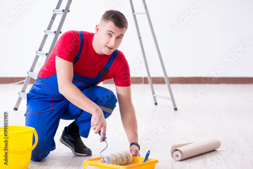 Male painter preparing for painting job at construction site