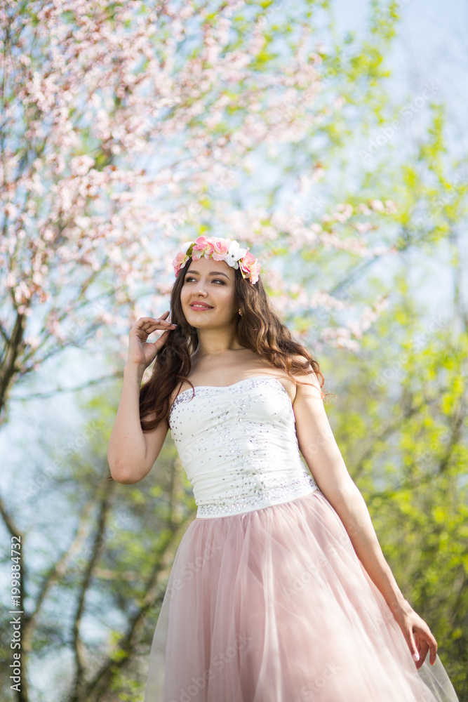 Young woman in the garden blooming in spring Young woman in the garden blooming in spring