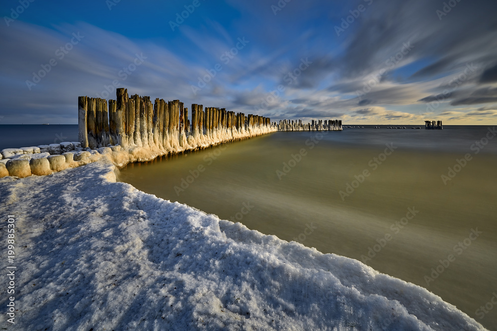Frozen wooden breakwaters line to the world war II torpedo platform at Baltic Sea, Babie Doly, Poland Frozen wooden breakwaters line to the world war II torpedo platform at Baltic Sea, Babie Doly, Poland