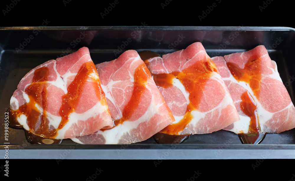 Thin sliced pork meat in black plate prepared for shabu or sukiyaki hot pot. Thin sliced pork meat in black plate prepared for shabu or sukiyaki hot pot.