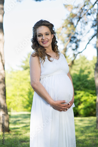 Pregnant woman in a spring park