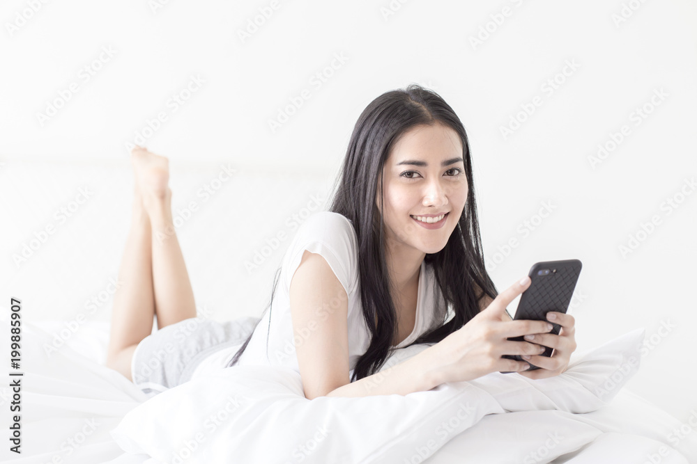 Asian woman using smartphone at home. People with technology concept. Asian woman using smartphone at home. People with technology concept.