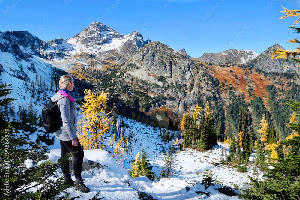 Exploring Pacific Northwest. Woman on vacation hiking in Cascade Mountains in autumn.  Mount Rainier National Park. Seattle. Winthrop. WA. United States.
