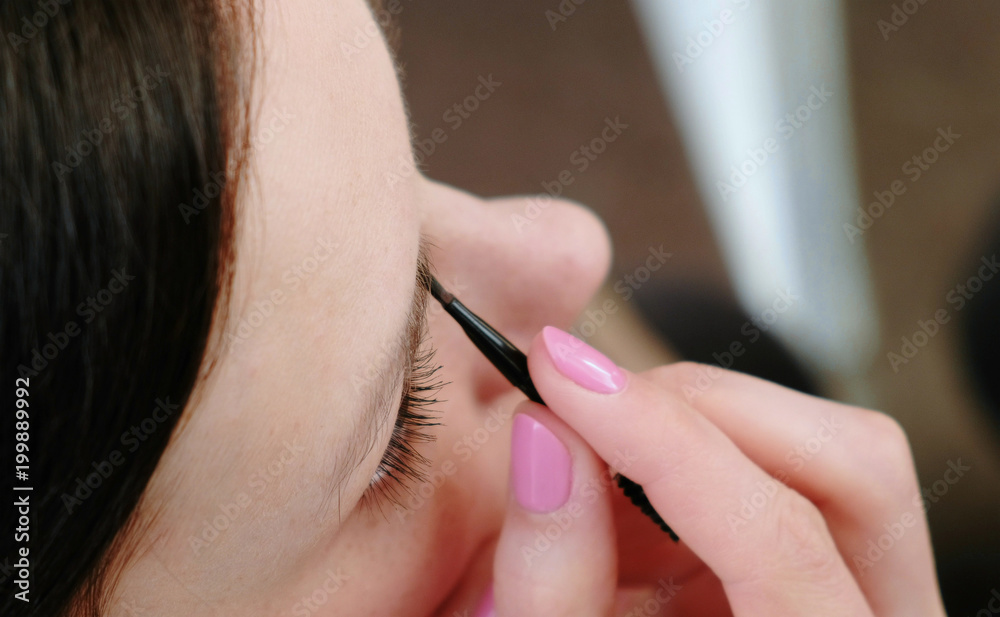 Close-up of a beautiful woman paints her eyebrows. Top view. Close-up of a beautiful woman paints her eyebrows. Top view.