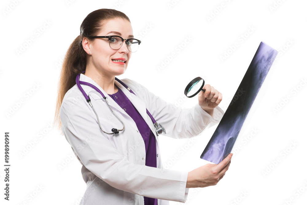 Attractive young woman doctor looking at x-ray making diagnosis in white uniform on white background Attractive young woman doctor looking at x-ray making diagnosis in white uniform on white background