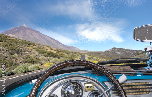 view from the inside of a retro cabriolet traveling on a tourist road on Tenerife