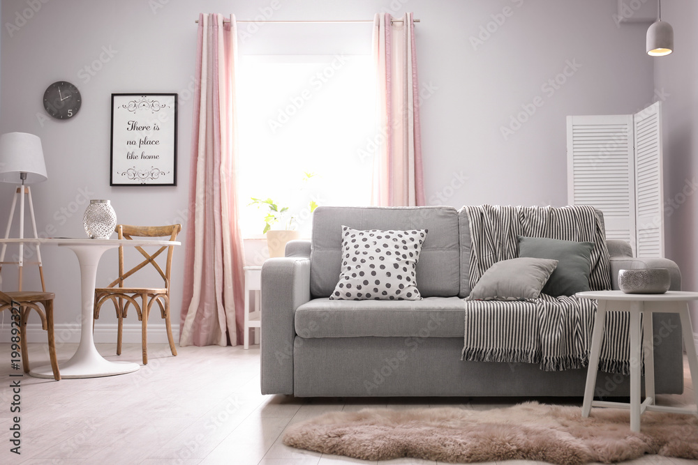 Fototapeta premium Stylish living room interior with comfortable couch