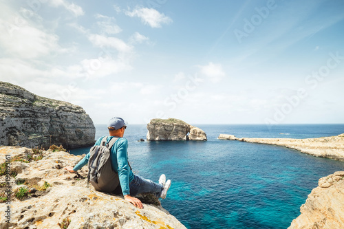 Coastal walker relax on rocky seaside photo